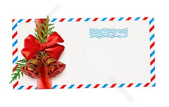 Empty envelope with red and blue borders and stamp tied with ribbon bow and Christmas decorations