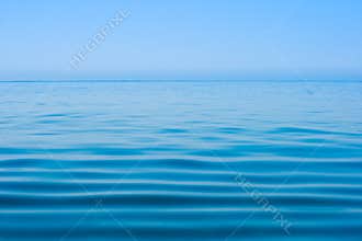 Still calm sea or ocean water surface and horizon