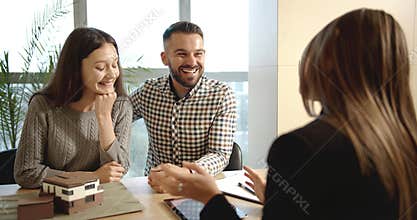 Clients talking with real estate manager
