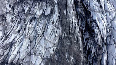 Aerial drone high angle view of the melting Solheimajokull glacier in Iceland. Climate change, melting glaciers, global warming