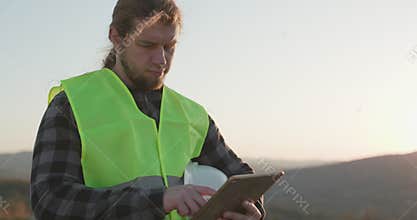 Businessman Engineer worker builder architect or engineer using tablet in industrial construction. Close-up of male man