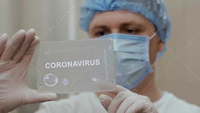 Doctor uses tablet with text Coronavirus