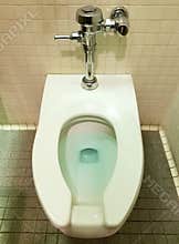 A clean toilet bowl with blue water