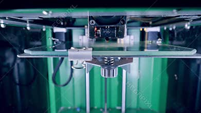 3D-printer head starts printing in a metal platform