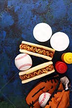 Grilled hot dogs with mustard and ketchup on the table with draft beer. Baseball party food with balls for the playoffs