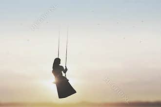 Free woman on the swing taking a breath in the sky