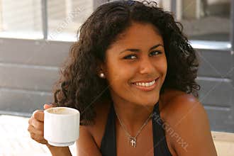 Beautiful brazilian woman having a coffee