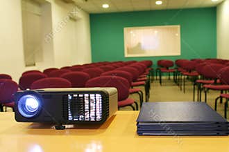 Projector on table with chairs behind (horizontal)