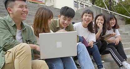 Group of student studying on the stairs  at campus