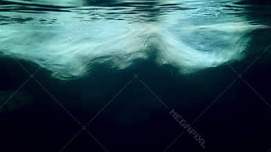 Underwater 4k video of iceberg floating in ocean. View on underwater part of ice in Antarctica