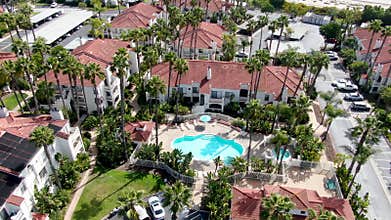 Aerial view of typical Southern California Spanish style residential condo with swimming pool