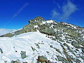 Alpine peak Falknis in the Ratikon border mountain massif or Raetikon Grenzmassiv and over the river Rhine valley Rheintal
