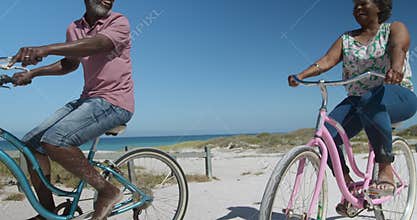 Side view old woman on a bike at the beach