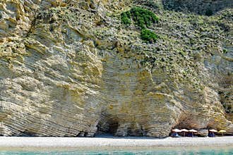 Chomi beach Paradise, white-yellow-brown rocks in layers