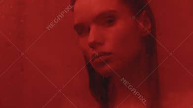 Wet woman posing for camera at washroom. Sexy woman looking at mirror in bath