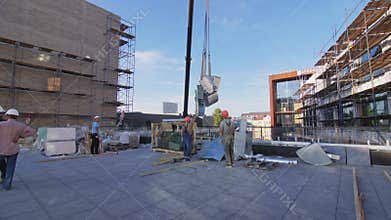 Crane carries air ventilation details to builders on rooftop