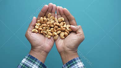 top view or men holding cashew nuts