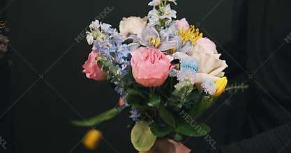 Florist creates a flower arrangement in a flower shop