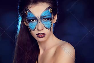 Fashion woman Portrait. Butterfly makeup, face art make up