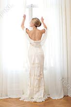 Elegant Bride Opening Window