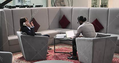 Multinational Business Duo Collaborating in Coworking Space