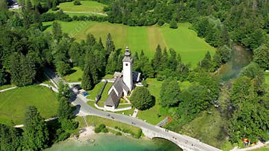 Aerial view of Bohinj lake in Julian Alps. Popular touristic destination in Slovenia. Bohinj Lake, Church of St John the Baptist.