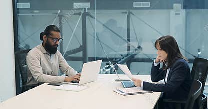 Multinational Business Couple Collaborating at Office Table
