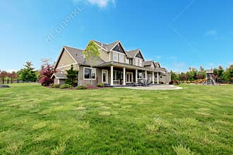 Large farm country house with spring green landscape.