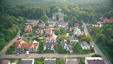 Aerial view of residential houses neighborhood and apartment building complex at sunset. Tightly packed homes, driveway surrounds