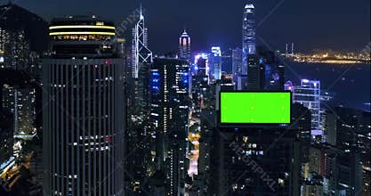 AERIAL. Top view of skyscrapers and green screen build board with tracking point. Bird view of modern city at night