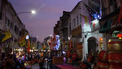 Slow motion Penang Chinese lion dance at stilt in beauty blue hour
