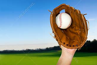 Baseball caught in glove outdoors