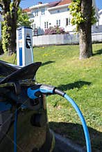 A static shot of a solid black Tesla Model 3 dual motor charging at the Recharge AC charging station
