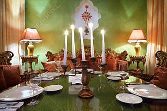 Candlestick with candles at table with serving