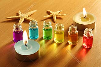 Six bottles with aroma oils, candles and starfish