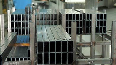 Metal or iron pipe in square box shape. warehouse of metal products. Metal square box pipes in stacks, packs at the