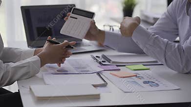Businessman in office: business meeting of two businessmen using laptop computer and talking