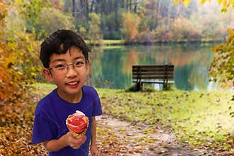 Cute Boy Eating Ice Cream in the Park