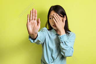Korean Woman Gesturing Stop And Covering Face Over Yellow Background