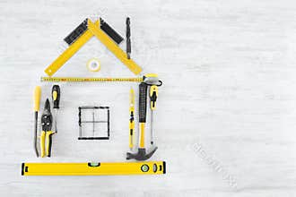 Tools Shape of House, Home Improve and Repair Concept. Wooden Background