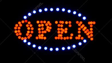 Defocused real LED Sign OPEN blinking at the entrance of a night storefront, restaurant, motel and night business.