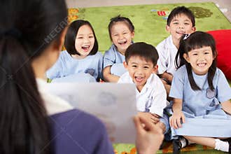 Teacher Showing Painting To Chinese Students