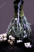 Fir tree in dress shape - creative idea for Christmas, greenery and moss. In the foreground bowls with balls and stars.