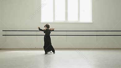 Little boy and girl dance waltz in a choreography lesson