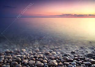 Sea pebble. Nature composition of sunset.
