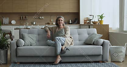 Pretty middle aged 40s natural grey haired woman home portrait
