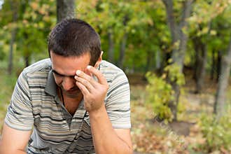 Worried man with hand to forehead
