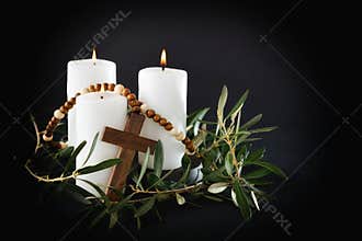 Easter religious dark background with candles cross and olive branches