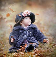 Little girl in autumn park