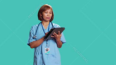 Nurse imputing medical data on tablet